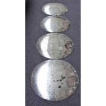 A set of four convex wall mirrors with pitted plates, each approx 58cm diameter, (4).