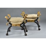 A pair of Regency style ebonised parcel gilt 'X' frame stools,