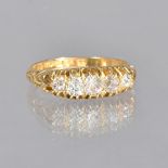 An 18ct gold and diamond set five stone ring, mounted with a row of cushion shaped idamonds,