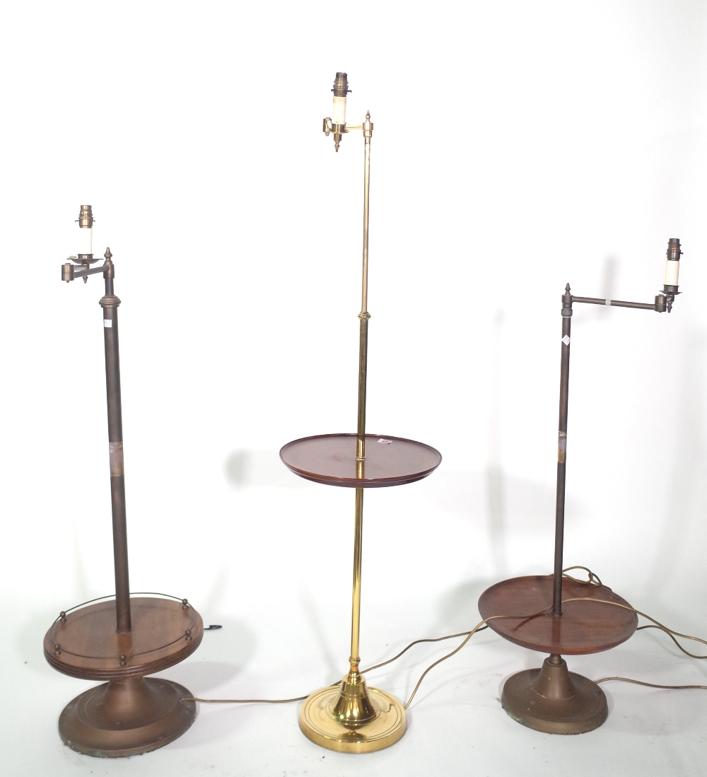 Three similar tubular metal standard lamps with adjustable anglepoise arm,