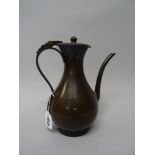 A Japanese bronze coffee pot, Meiji period, of slender pear form with hinged cover and curved spout,
