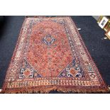 A Ghashgai carpet, South Persian, the floral madder field with a hooked central medallion,