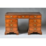 An 18th century style mahogany pedestal desk with nine drawers about the knee on ogee bracket feet,