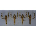 A set of four Louis XVI style gilt brass two branch wall appliques, early 20th century,