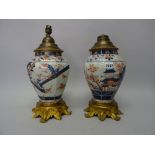 A pair of Japanese Imari ormolu mounted vases, Edo period, of octagonal baluster form,