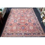 A Mahal carpet, Persian, the madder field with an allover flowerhead design,