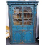 A 19th century Irish blue painted pine corner cupboard with pair of astragal glazed doors over