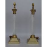 A pair of Victorian style brass and glass table lamps, each of spiral twist, corinthian column form,