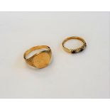 A 9ct gold signet ring, decorated with bark textured shoulders,