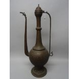 A large Kashmir engraved copper ewer, 19th century, of pear form with pierced foot,
