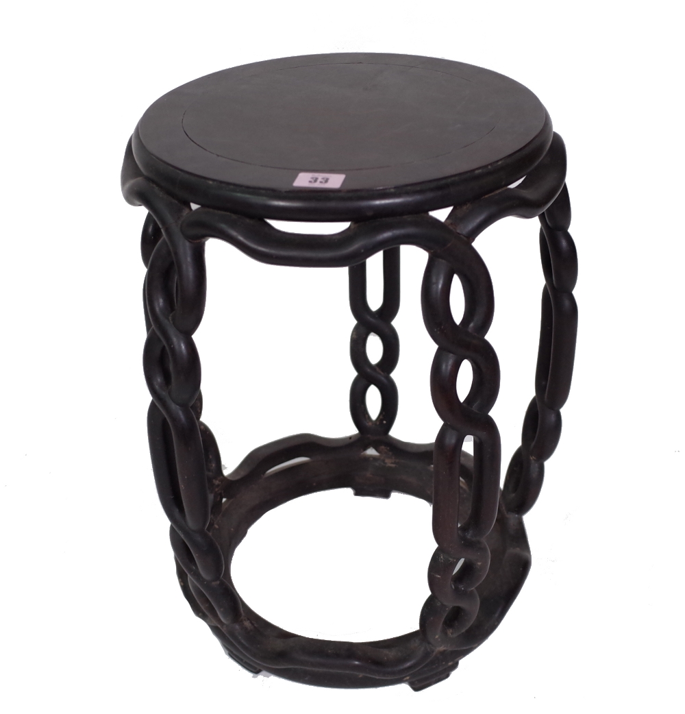 A late 19th century Chinese hardwood barrel stool, with open pierced interlaced supports,