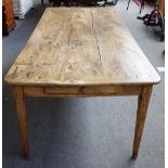 An early 19th century French elm plank top kitchen table, with double end frieze drawer,