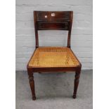 A Regency mahogany and beech side chair, with cane seat on turned supports,