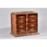 A Victorian Gothic Revival walnut and faux figured walnut table top cabinet with two rows of four
