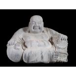 A modern stone figure of a seated Buddha,