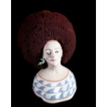 A 21st century stylised pottery bust of a woman, with serpent earrings and natural sea sponge hair,