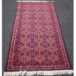 A Baluchistan rug, the field filled with three columns of leaf diamonds, minor borders,