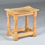 A Robert 'Mouseman' Thompson oak stool with adze top, on octagonal baluster supports,