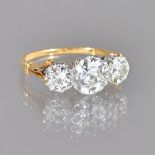 A gold and diamond three stone ring,