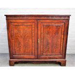 A mid-18th century mahogany side cabinet, the pair of panel doors enclosing a pair of linen trays,