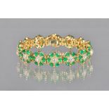 A gold, emerald and diamond bracelet, in a shaped circular cluster link design,