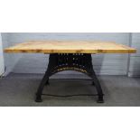 Industrial design oak plank top table on a black painted parcel gilt cast iron base,