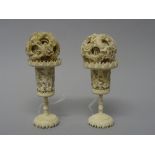 A near pair of Canton carved ivory puzzle balls on stands, late 19th/early 20th century,