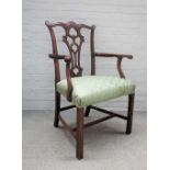 A 19th century mahogany open armchair of mid-18th century design with pierced splat on canted block