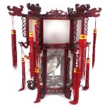 A modern Chinese hanging lantern with carved hardwood octagonal frame,