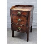 A George III mahogany night stand, the galleried top over two drawers and cupboard,