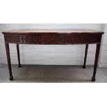 A George II style mahogany bowfront serving table with carved frieze on channelled tapering square