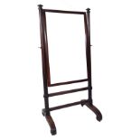 An early Victorian rosewood cheval mirror, the rectangular plate within turned uprights,