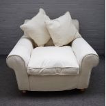 A modern easy armchair with cream loose cover upholstery, 110cm wide x 72cm high,