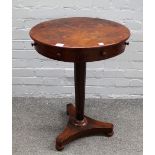 A William IV mahogany circular occasional table with four true and four dummy frieze drawers on