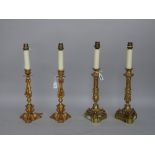 A pair of modern gilt metal table lamps of 18th century 'candlestick' form raised on a triform base,