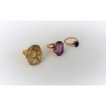 A gold ring, claw set with an oval cut smoky quartz, a gold ring,