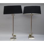 A pair of Porta Romana nickel finish table lamps with oval silk shades, 81cm high overall.