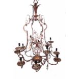 A modern gilt metal and glass twelve branch chandelier of shaped open cage form with central