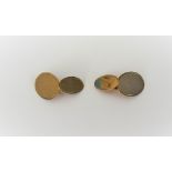 A pair of 9ct gold cufflinks, the larger oval fronts with engine turned decoration,