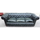 A 20th century green leather upholstered brass studded button back Chesterfield sofa on bun feet,