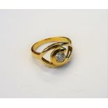 A gold and diamond single stone ring, mounted with a circular cut diamond in an open work setting,