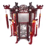 A modern Chinese hanging lantern with carved hardwood octagonal frame,