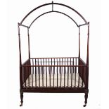 A 19th century campaign style mahogany arch top child's crib, 121cm wide x 90cm deep x 185cm high.