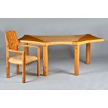 John Makepeace, a burr elm desk of shaped outline with leather inset top on turned supports,