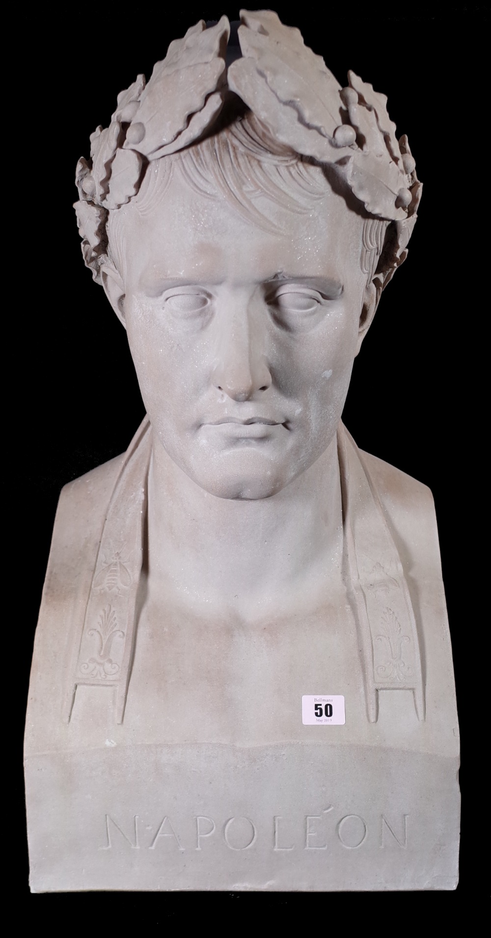 A modern composite marble bust of Napoleon wearing a laurel wreath, 66cm high.