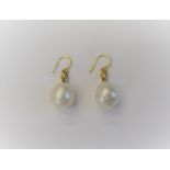 A pair of cultured pearl and diamond pendant earrings,