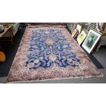 A large Kerman carpet, Persian, the indigo field with a central medallion swathes of floral sprays,