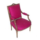 A Louis XVI style giltwood open arm fauteuil, with pink upholstery.