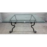 A late 20th century square wrought iron coffee table with bevelled glass top,