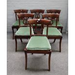 A set of six early 19th century French mahogany framed dining chairs with lyre backs on sabre